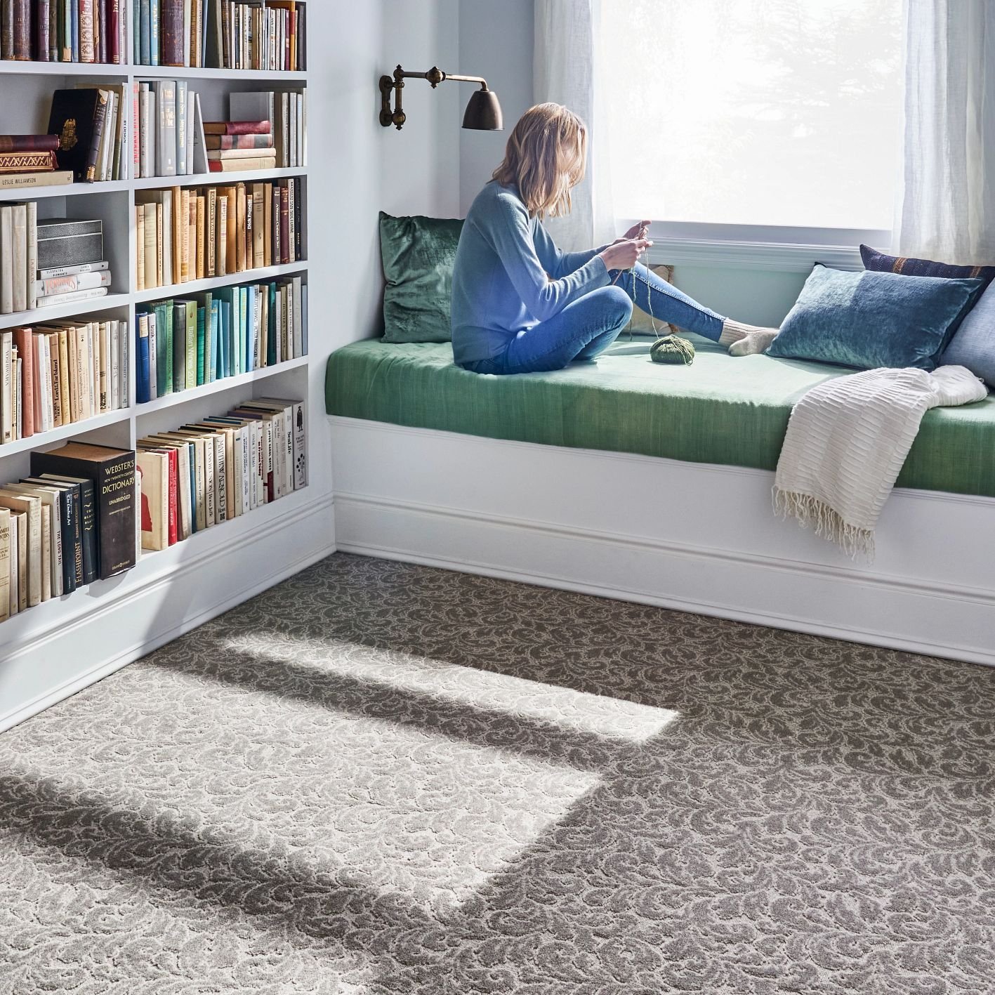 Girl reading in a bedroom with white furniture and brown patterned carpet from Builder's Discount Floor Covering Jacksonville Beach